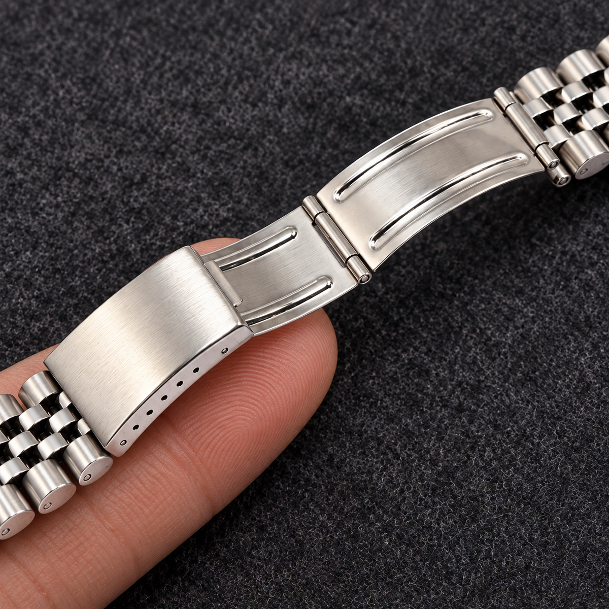 5-link curved end stainless steel watch bracelet folding clasp detail