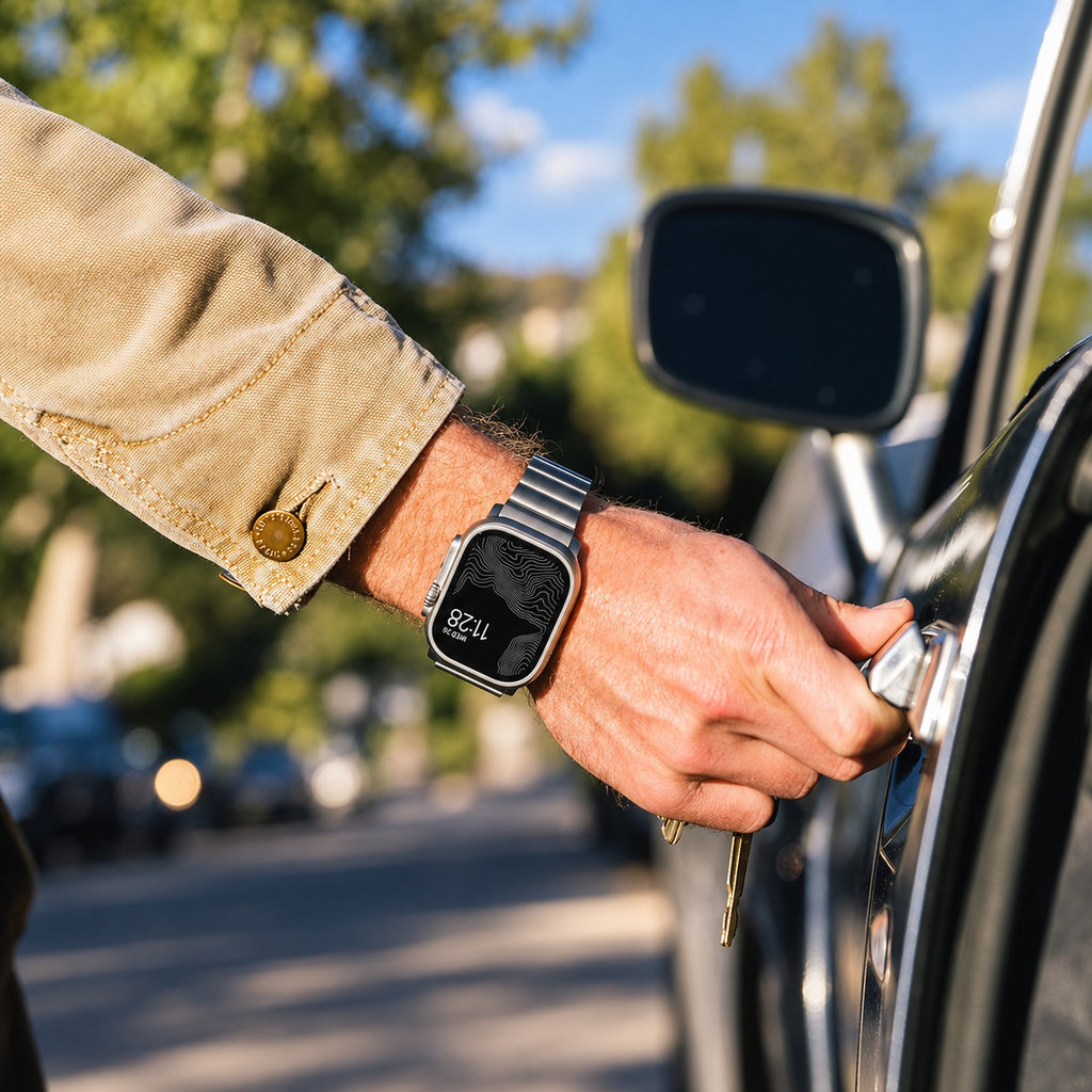Flat-Link Stainless Steel Band for Apple Watch, Space Gray, worn on the wrist opening a car door