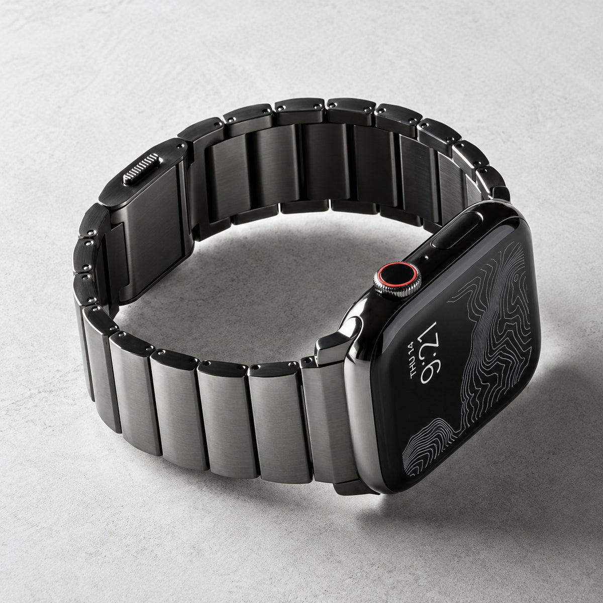 Flat-Link Stainless Steel Band for Apple Watch, Space Gray, on a desk, angled