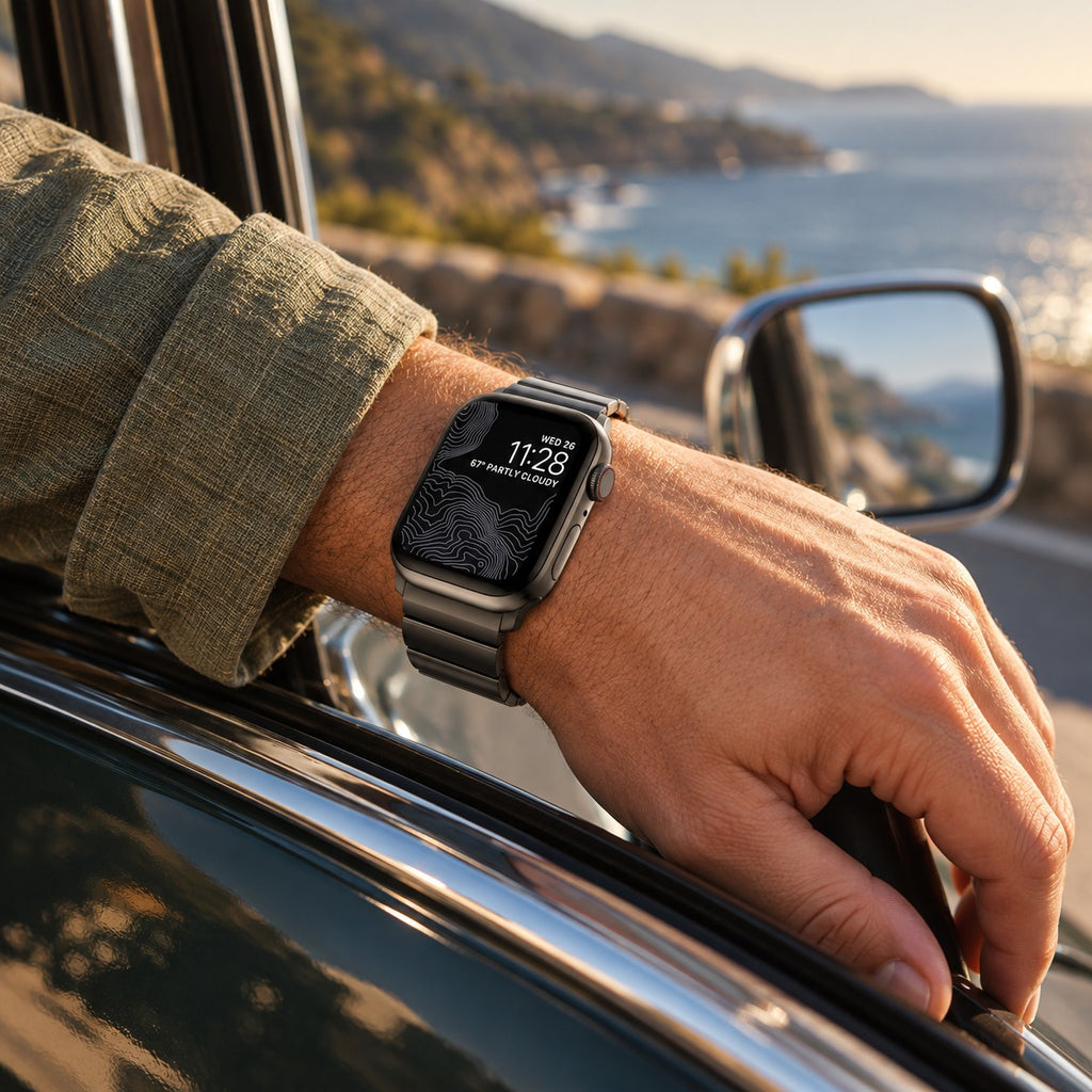 Flat-Link Stainless Steel Band for Apple Watch, Space Gray, worn on the wrist by a car window