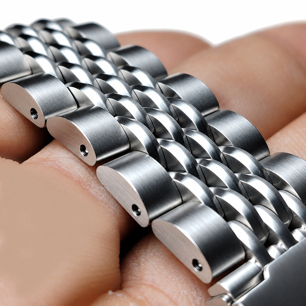 Beads of rice stainless steel watch bracelet held in hand