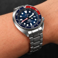 Silver curved end stainless steel bracelet worn on a Seiko Turtle-style dive watch