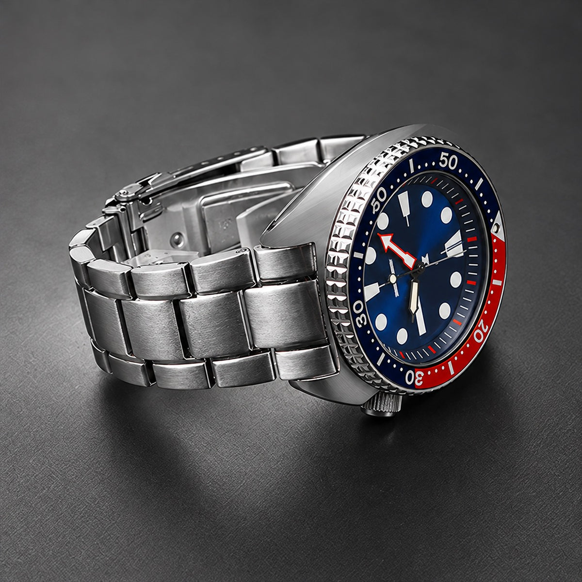 Silver 22mm curved end bracelet on a Turtle-style cushion-case dive watch, side view